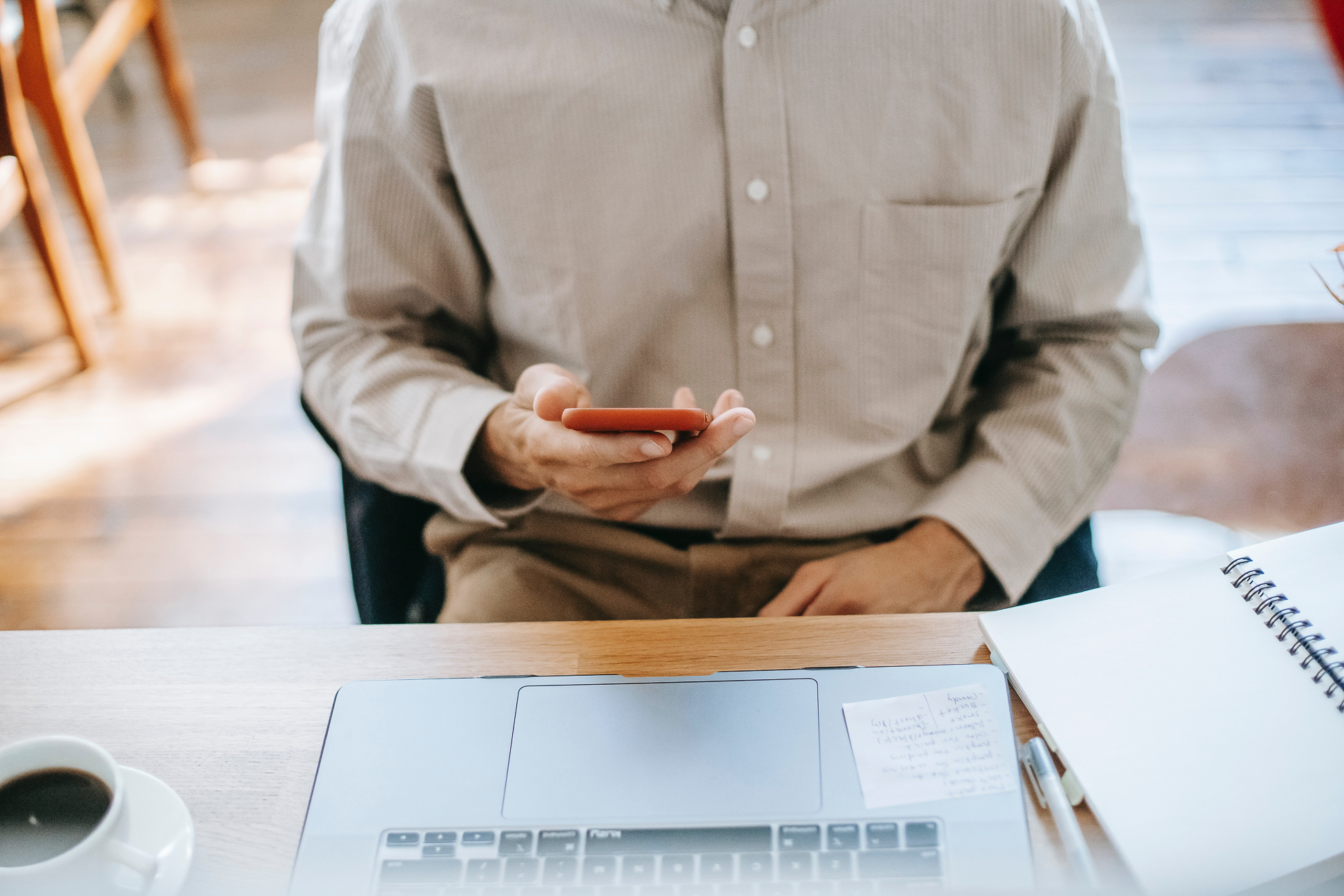 Man on phone near laptop