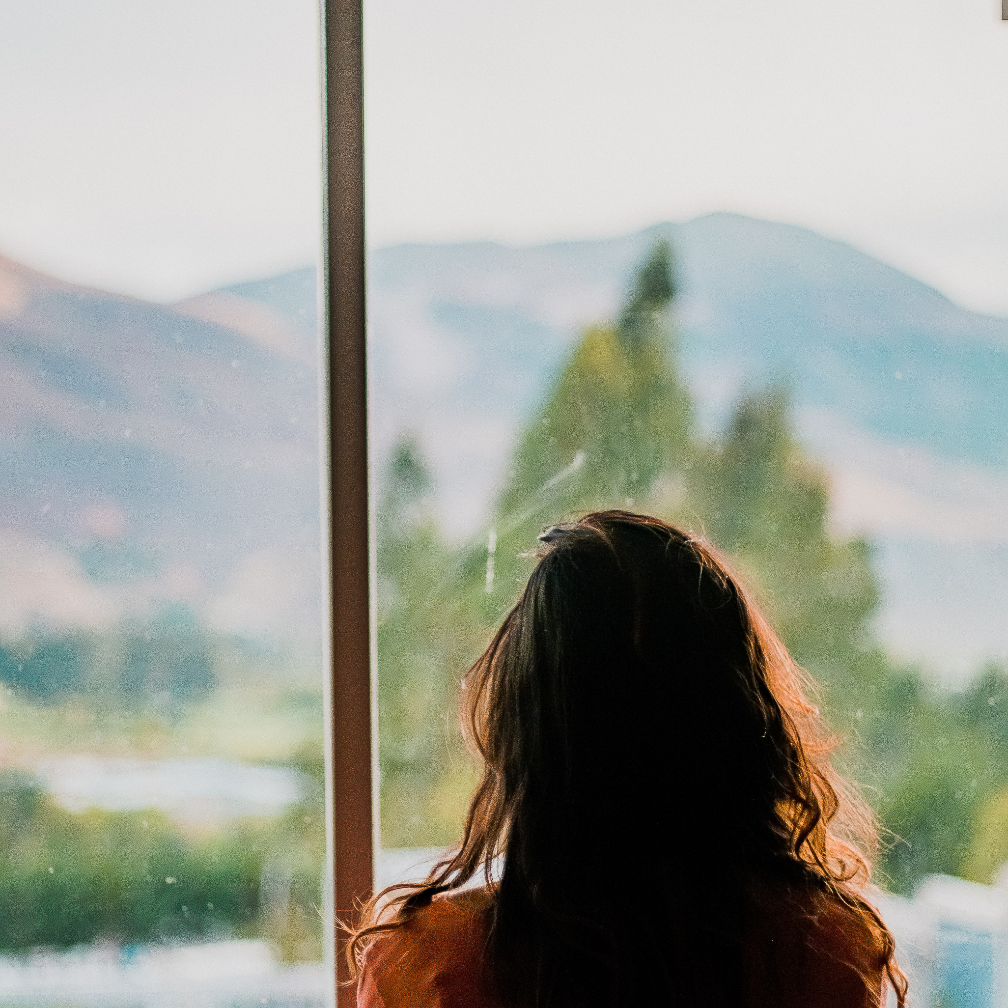 woman looking through a window